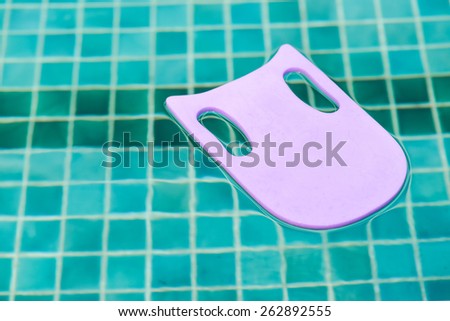 Blue foam board for the teaching of swimming beside swimming pool