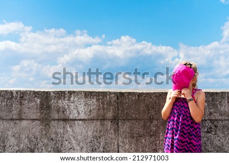 A small girl with head in the clouds