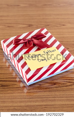 gift box with card write happy father day on wood background