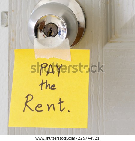 sticky note write a message pay the rent on the latch door
