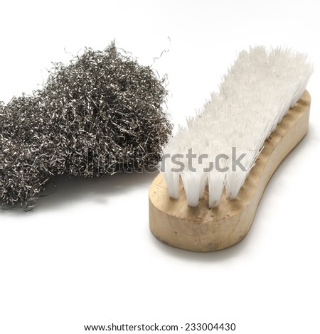 dirty wash brush and steel wool on a white background