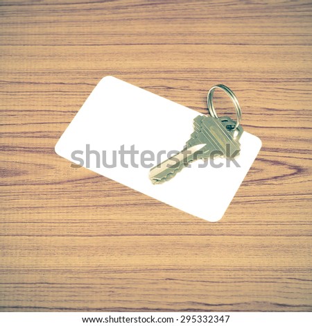 business card and keys on wood background vintage style