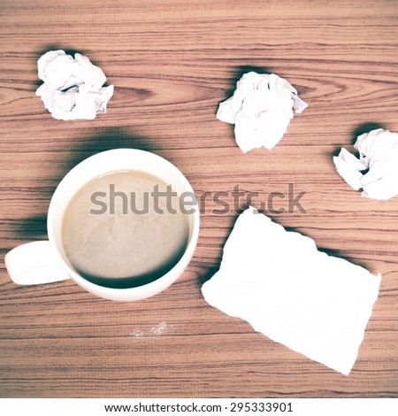 coffe cup and crumpled for idea on wood background vintage style