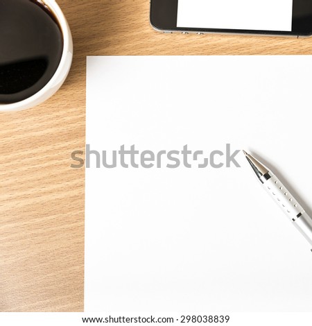 paper and pen with coffee cup and smart phone on wood background