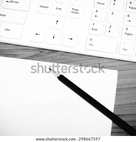 keyboard computer white paper and black pencil on wood background black and white color tone style