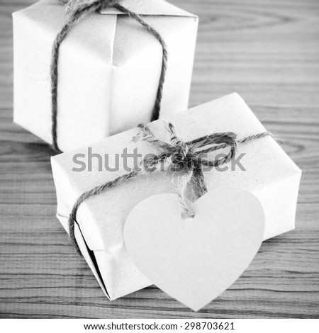 gift box with heart tag card on wood background black and white color tone style