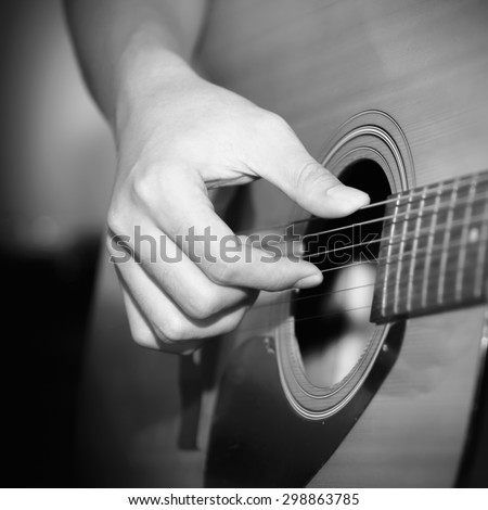 still life man playing guitar close up black and white color tone style