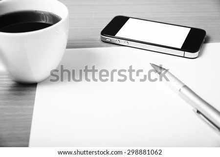 paper and pen with coffee cup and smart phone on wood background black and white color tone style