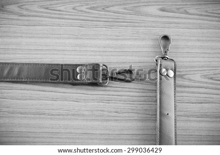 bag leather strap on wood background black and white color tone style