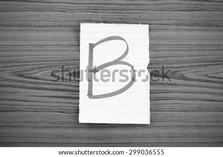 grade b on wood wall background black and white color tone style