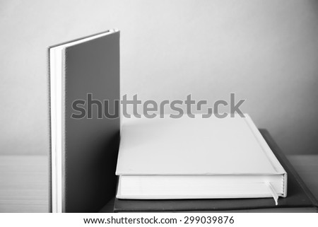 stack of book on wood table background black and white color tone style