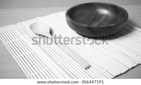 empty bowl with chopstick on wood table background black and white color tone style