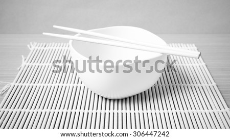 empty bowl with chopstick on wood table background black and white color tone style