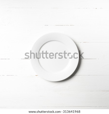 empty dish over white table background