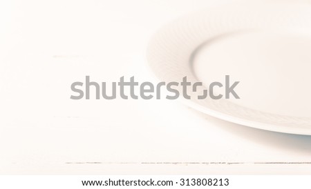 empty dish over white table background vintage style