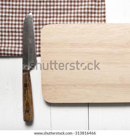 kitchen knife on cutting board over white table background