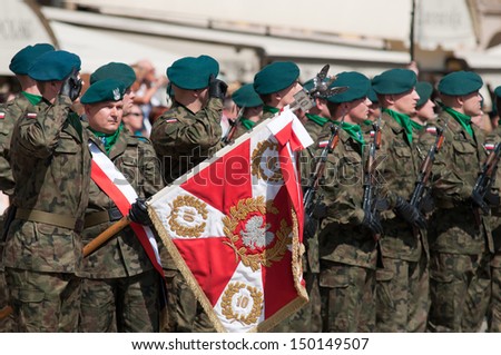 Wroclaw - August 15: Soldier salute with Polish coat of arms (Day of Polish Army) on 6 July 2013 in Wroclaw, Poland