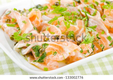 Salmon carpaccio - fresh salmon slices in marinade