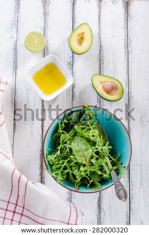 simple fresh salad ingredients on white wooden background