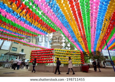 Seoul, South Korea - April 18, 2014: People visiting the Jogyesa Temple where hanging colorful lanterns for celebration of Lotus Lantern Festival in Seoul, South Korea.