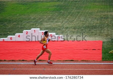 BAIXIANG COUNTY, HEBEI PROVINCE, CHINA -  - June 2012: On June 1, 2012 Chinese University Games, in the men\'s 10,000 m race, the athletes worked hard on the runway.