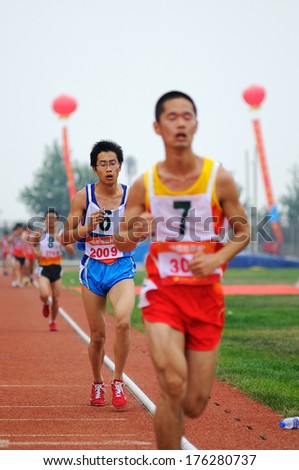 XINGTAI CITY, HEBEI PROVINCE, CHINA - June 2012: On June 1, 2012 Chinese University Games, in the men\'s 10,000 m race, the athletes worked hard on the runway.