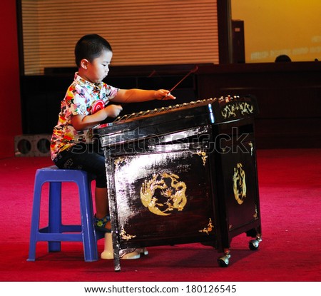 Shijiazhuang City, Hebei Province, China July 7: On July 7, 2012 in Hebei Province, China Youth Arts Festival Area, an unidentified boy  playing traditional Chinese instruments, the dulcimer.