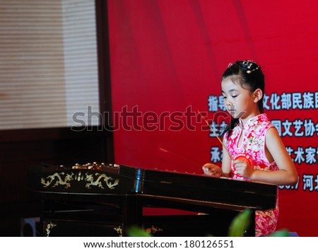 Shijiazhuang City, Hebei Province, China July 7: On July 7, 2012 in Hebei Province, China Youth Arts Festival Area, an unidentified girl  playing traditional Chinese instruments, the dulcimer.