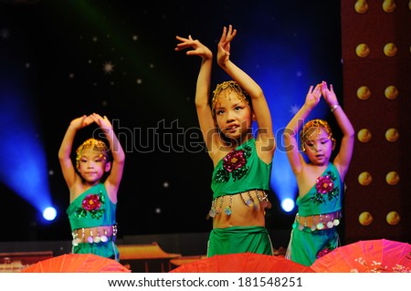 SHIJIAZHUANG CITY, CHINA - JULY 7: On July 7, 2012 in Shijiazhuang City, China Youth Arts Festival Unidentified group of cute kids performing traditional Chinese Dai dance flavor.