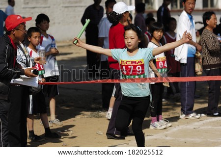 BAIXING COUNTY, CHINA - MAY 12, 2011: Baixiang County Middle School Track Meet held in May 12, 2011. Unidentified Student athletes worked hard toward the finish line.