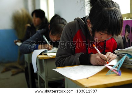 XINGTAI CITY, CHINA - APRIL 1,2010: In April 1, 2010, Baixiang County school exams, unidentified students write papers in a serious answer.