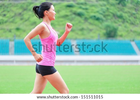 asian woman runner running in sports ground outdoor