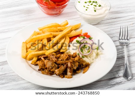 Kebab plate with french fries fresh cole slaw and onions