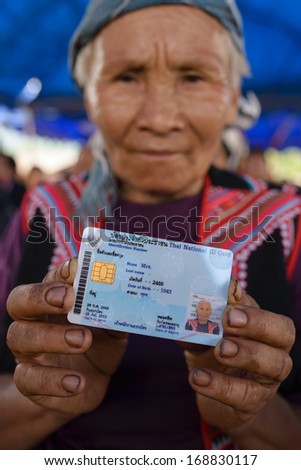 CHIANGRAI - AUGUST 2, 2013 : Unidentified hill tribe show her national id card in Chiang Rai, Thailand.
