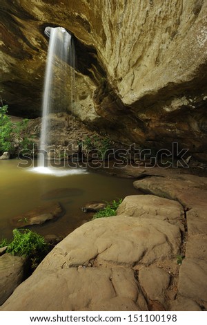 Waterfall flows into holes at Sang Chan Waterfall.