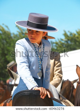 TARIFA, SPAIN - SEPTEMBER 05: an unidentified child at Fair of Tarifa with a horse rider procession on September 05, 2010 in Tarifa. About 500 riders participate in the procession, bringing the Virgin de la Luz to the town