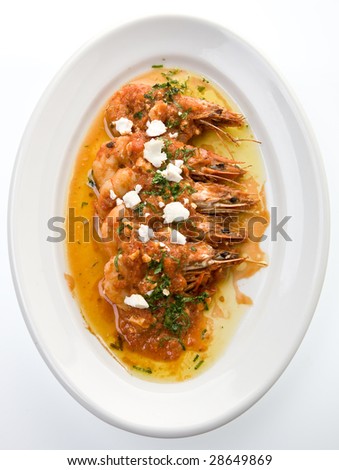 Grilled shrimps covered with feta cheese sauce