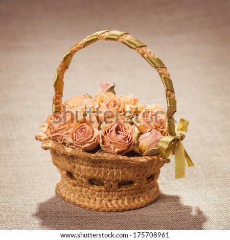 Cart with dry roses on canvas