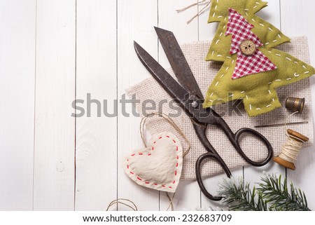 Vintage scissors surrounded by Christmas decorations, hand-made