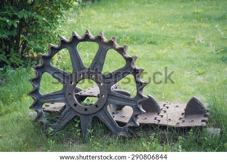 Old rusty wheel and part of the caterpillars