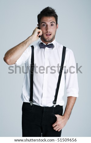 Portrait Of Nerdy Young Man In Suspenders On The Phone, Studio Shot ...