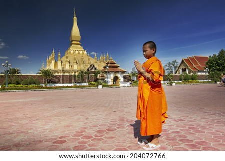 VIENTIANE-JULY 4: Monks leave the monastery after a religious liturgy on july 4, 2014 in Vientiane, Laos.