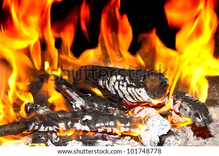Burning open fireplace with fire, flame, wood and embers