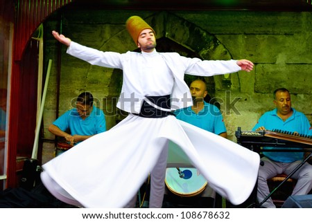 ISTANBUL - JULY 25: Sufi whirling dervish (Semazen) dances at Sultanahmet during month of Ramadan on July 25, 2012 in Istanbul. Semazen conveys God\'s spiritual gift to those are witnessing the ritual.