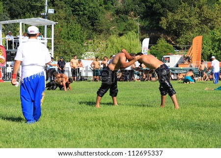 ISTANBUL - AUGUST 24: Unidentified wrestlers in the 8th Sile Annual Oil Wrestling Event on August 24, 2012 in Istanbul. Oil wrestlers engaging in the arena.