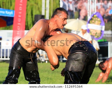 ISTANBUL - AUGUST 24: Unidentified wrestlers in the 8th Sile Annual Oil Wrestling Event on August 24, 2012 in Istanbul. Close up of oil wrestler (Pehlivan) in a tight headlock..