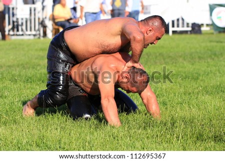 ISTANBUL - AUGUST 24: Unidentified wrestlers in the 8th Sile Annual Oil Wrestling Event on August 24, 2012 in Istanbul. Wrestler fighting an opponent