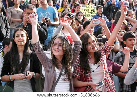 ISTANBUL - APRIL 25: Fans of MANGA rock group. Famous Turkish nu-metal group is performing live on the stage at Maltepe. April 25, 2010 in Istanbul, Turkey.