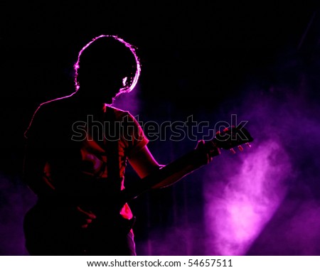 ISTANBUL - MAY 14: Band Mor ve Otesi performs live at Maltepe open air stage on May 14, 2010 in Istanbul, Turkey. Guitarist Kerem ozyegen of the rock group plays.
