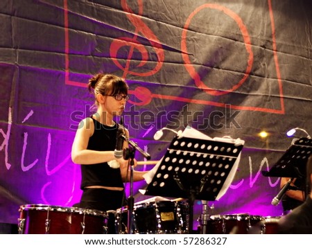 ISTANBUL - JULY 11: Members of the Maltepe Symphonic Orchestra perform live at Maltepe open air stage on July 11, 2010 in Istanbul. Drum player plays.